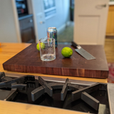Eaglecreek Boards professional end grain hardwood butcher block cutting board with a glass, limes, and knife.