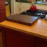 Eaglecreek Boards professional end grain hardwood cutting board resting on a kitchen island countertop