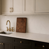 Eaglecreek Boards professional end grain hardwood cutting board standing on a marble kitchen countertop.