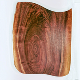 Eaglecreek Boards live edge black walnut wooden serving board with rich grain patterns and organic curved edges.