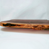 Eaglecreek Boards live edge black walnut wooden serving board with rich grain patterns and natural rustic finish.