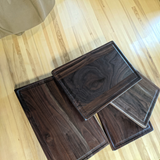 Eaglecreek Boards rectangular walnut wood cutting boards with juice grooves, showcasing rich dark wood grain patterns.