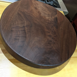 Eaglecreek Boards round dark wood cutting board with natural grain patterns, perfect for serving or food preparation.