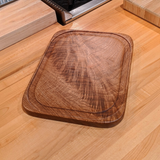 Eaglecreek Boards rectangular solid wood cutting board with a juice groove and rich natural grain on a kitchen counter.