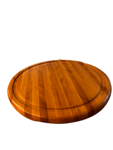 Wooden round cutting board on a white background