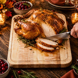 Eaglecreek Boards maple edge grain cutting board holding a roasted turkey being carved on a rustic holiday table