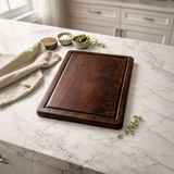 Eaglecreek Boards rectangular walnut wood cutting board with juice groove on a marble kitchen countertop