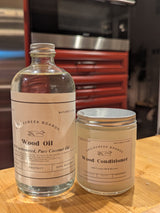 EagleCreek Boards Wood Oil and Wood Conditioner on a wooden surface with a blurred background.