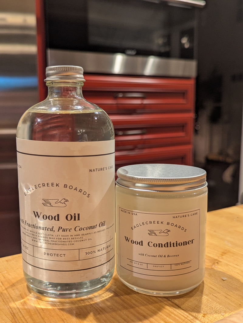 EagleCreek Boards Wood Oil and Wood Conditioner on a wooden surface with a blurred background.
